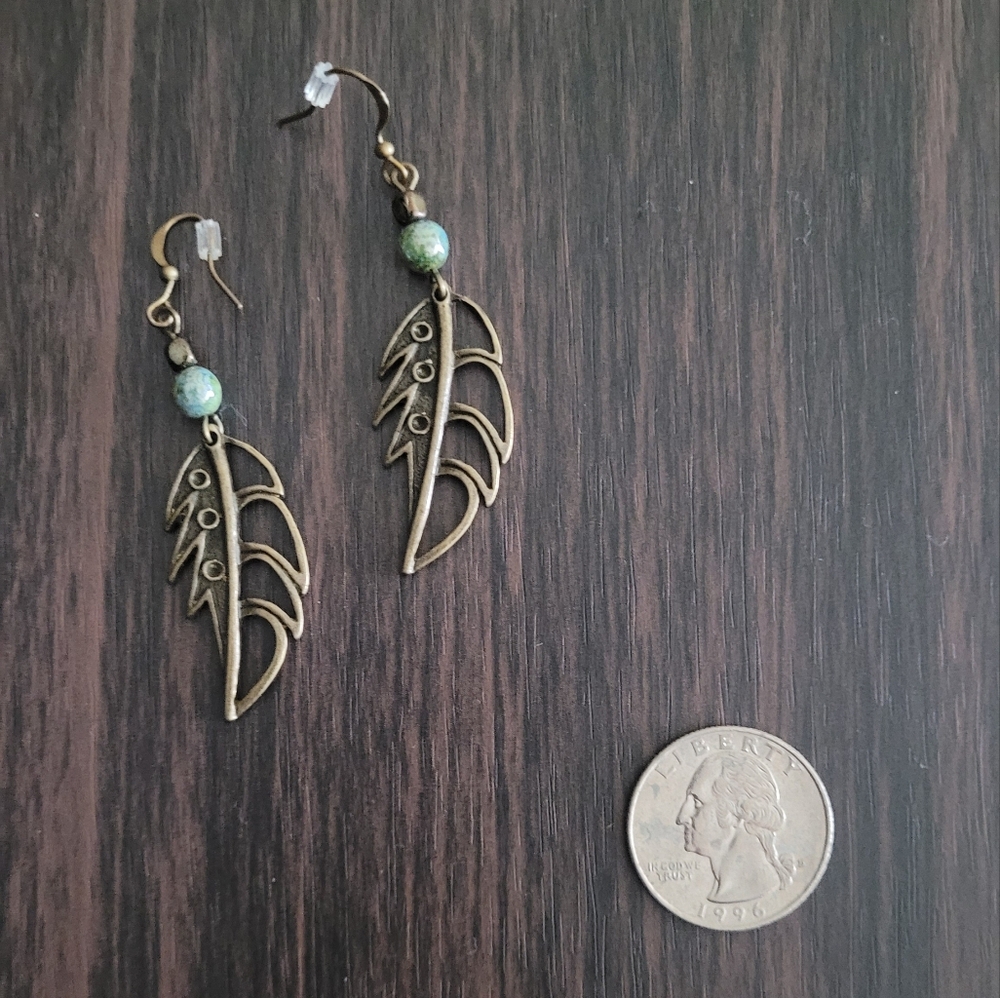 Brassy feather and bead dangle earrings